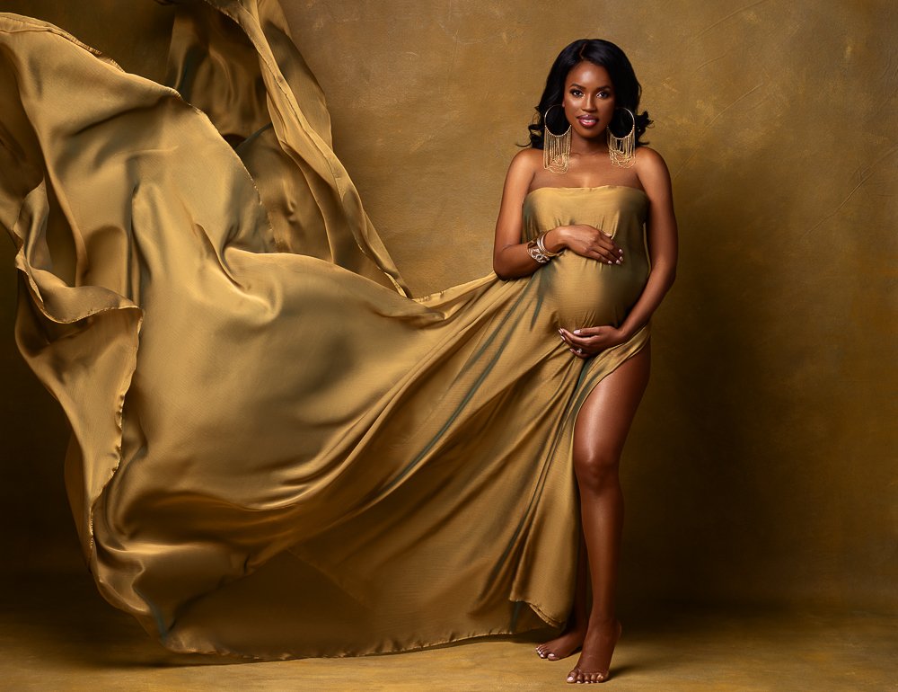 pregnant women doing maternity shoot on gold backdrop