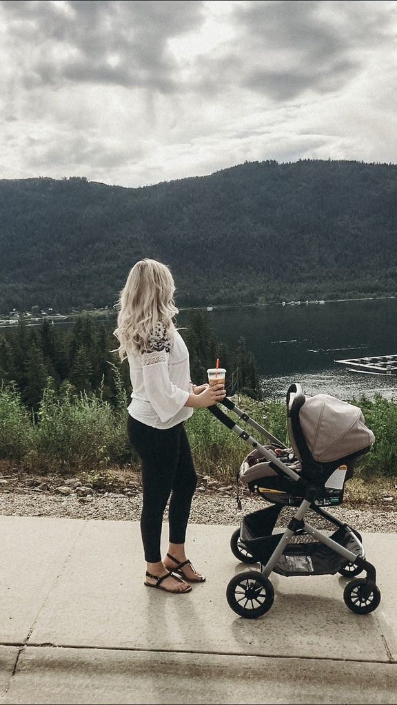 pregnant women walking baby in stroller at the park