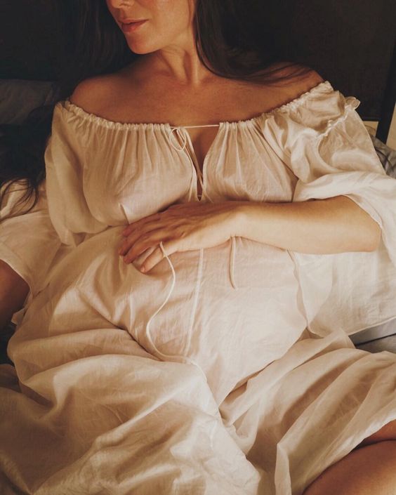 women wearing maternity night gown in bed