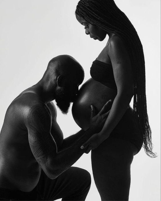 black couple taking black and white silhouettematernity photos