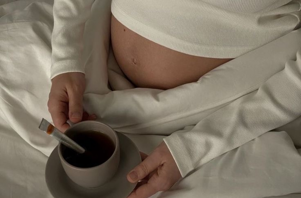 pregnant women drinking tea in bed.png